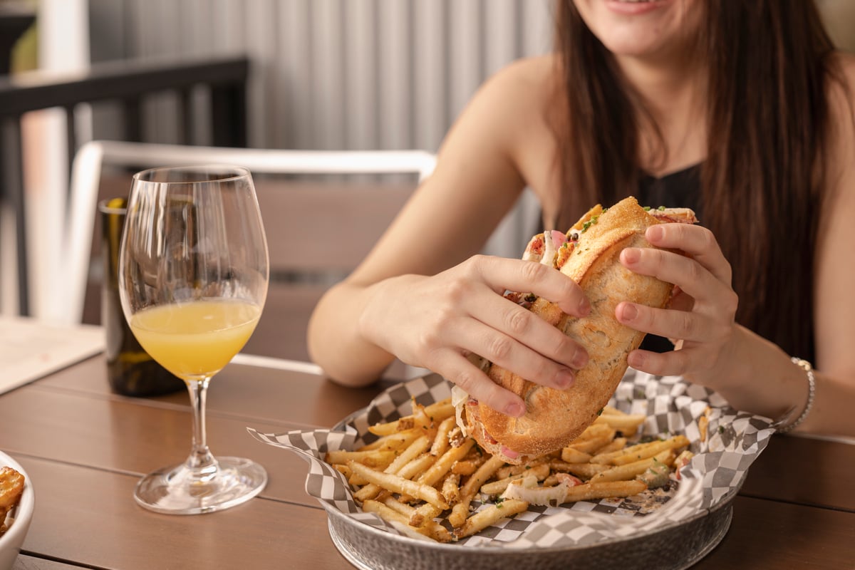 Woman eating a sandwich and fries at Tanglewood