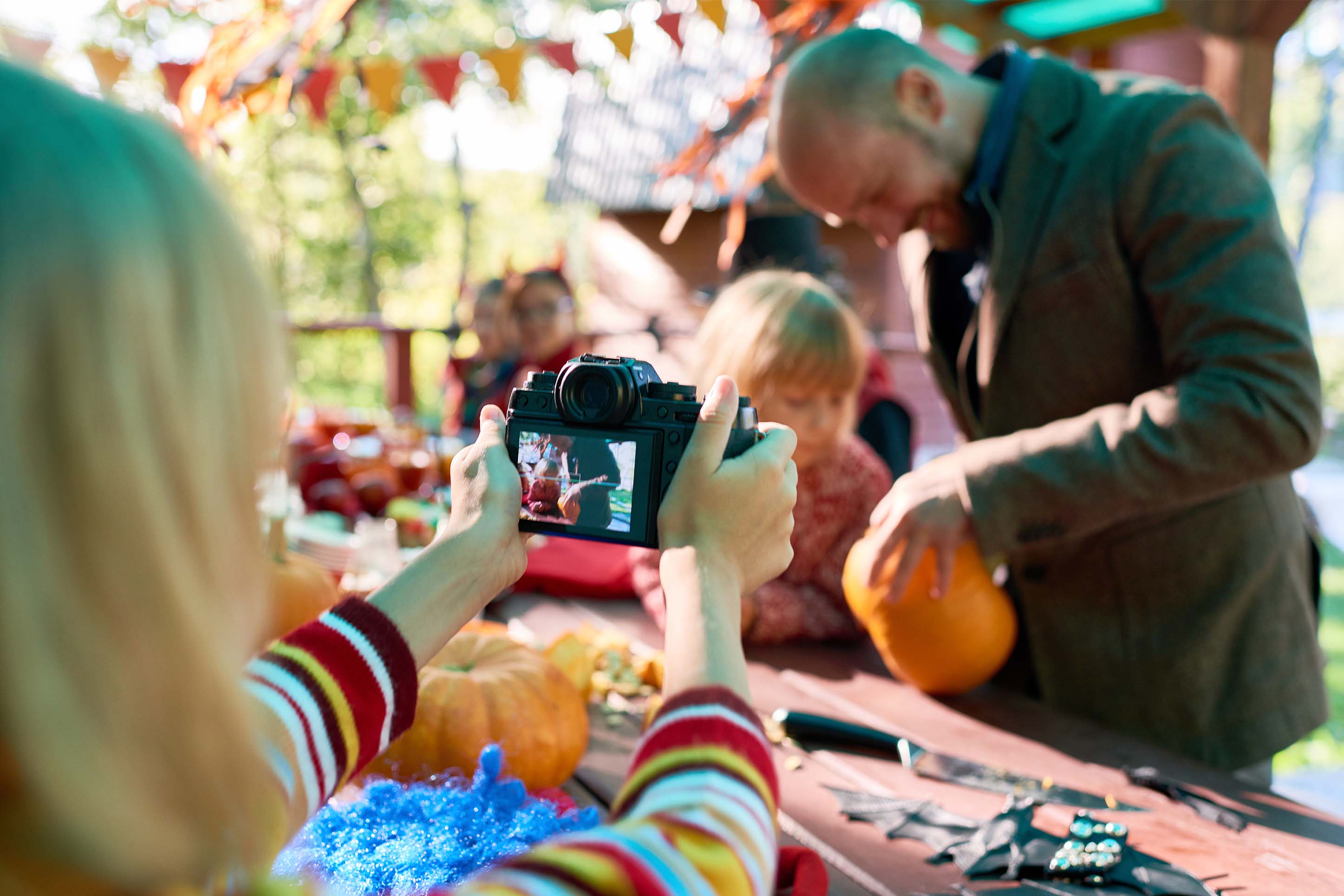 child decorating a pumpkin