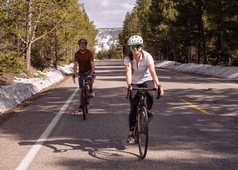 Two people biking in Yellowstone National Park