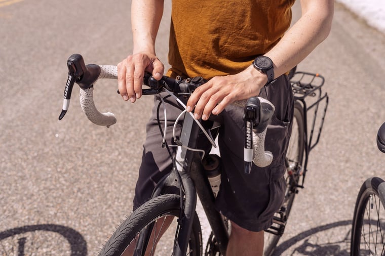 Close up of a person's hands on their road bike handles in Yellowstone National Park