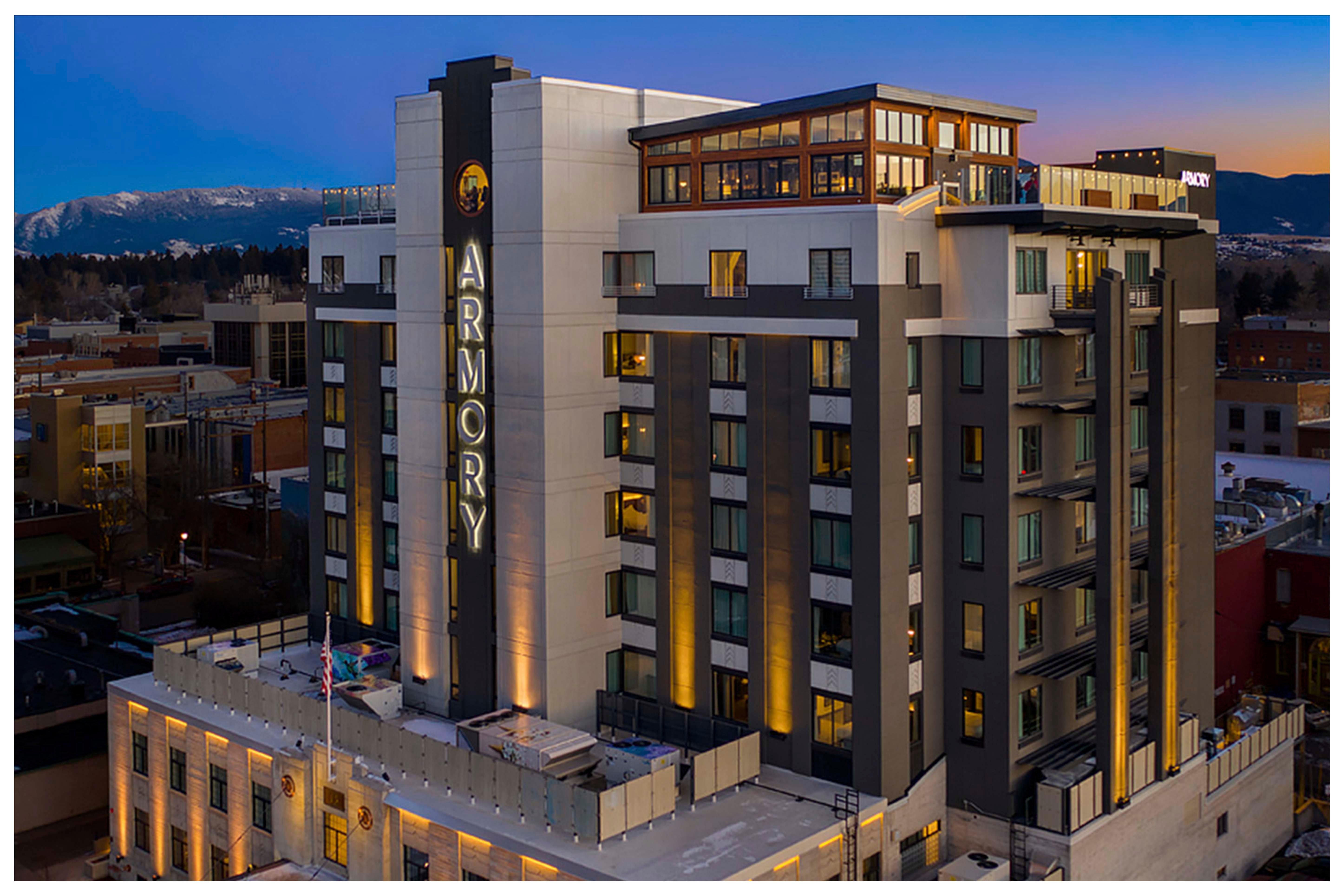 the kimpton armory hotel in bozeman, lit up at night