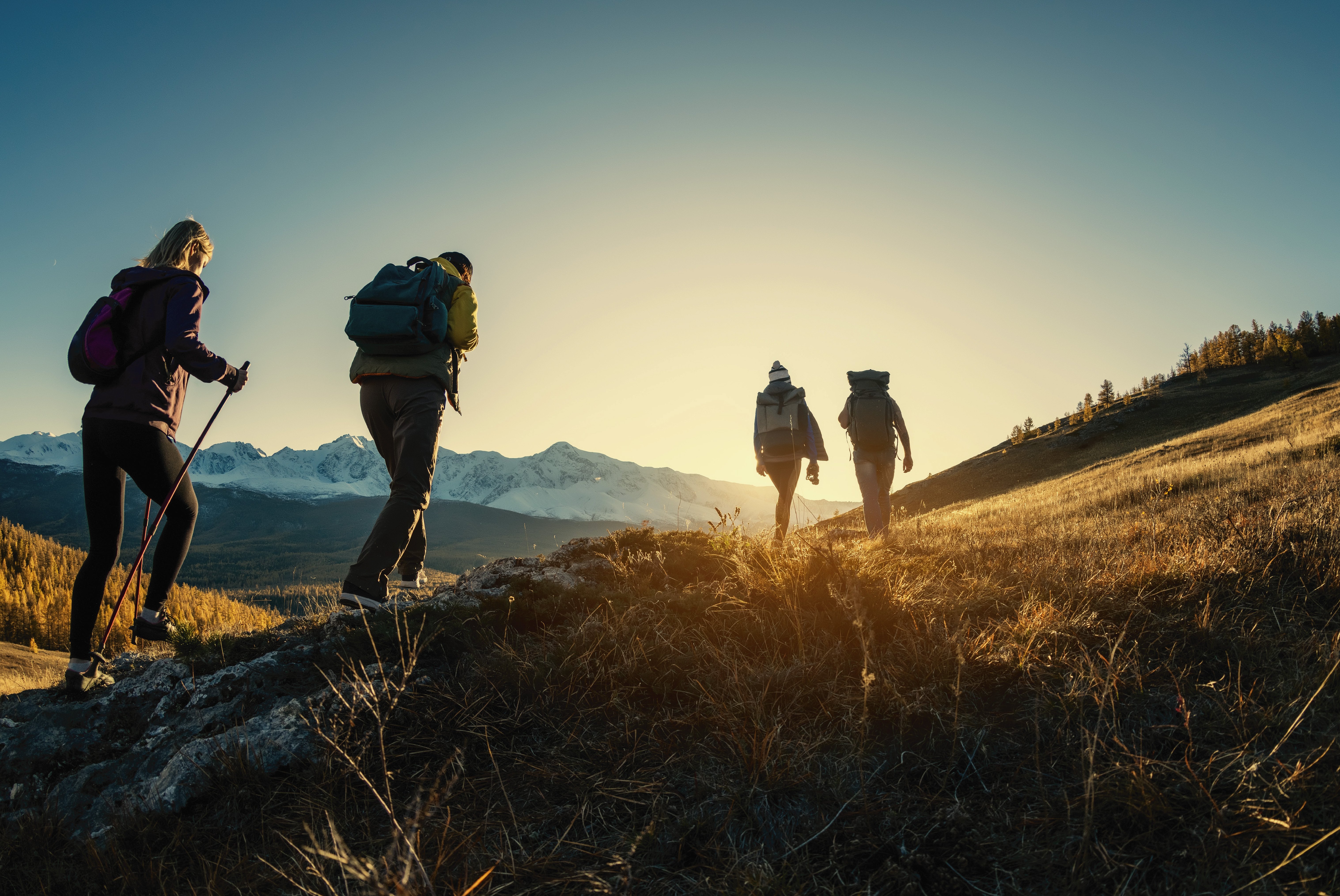 a group of people hiking in the mountains of montana