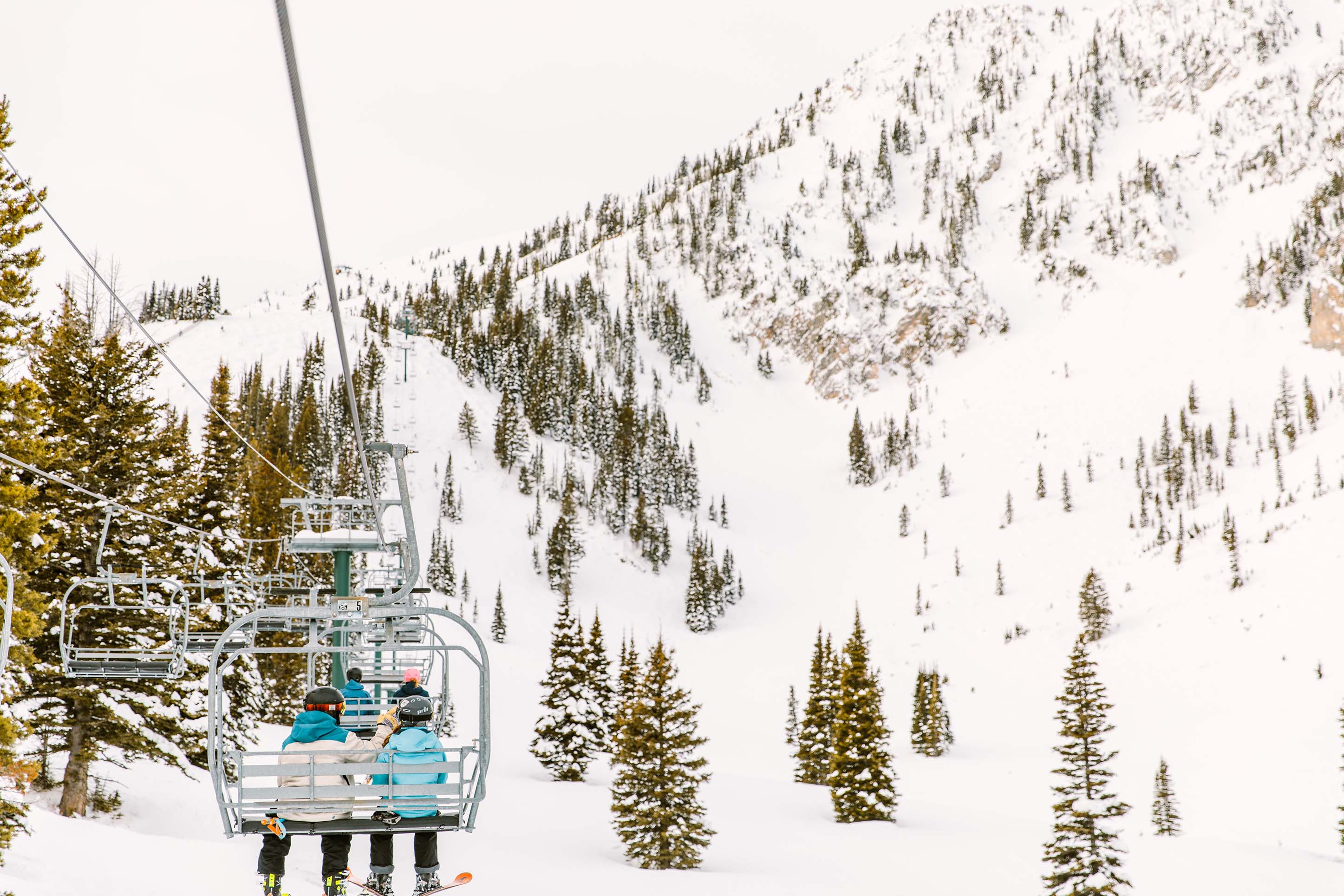 two people riding a ski lift at Bridger Bowl in Bozeman