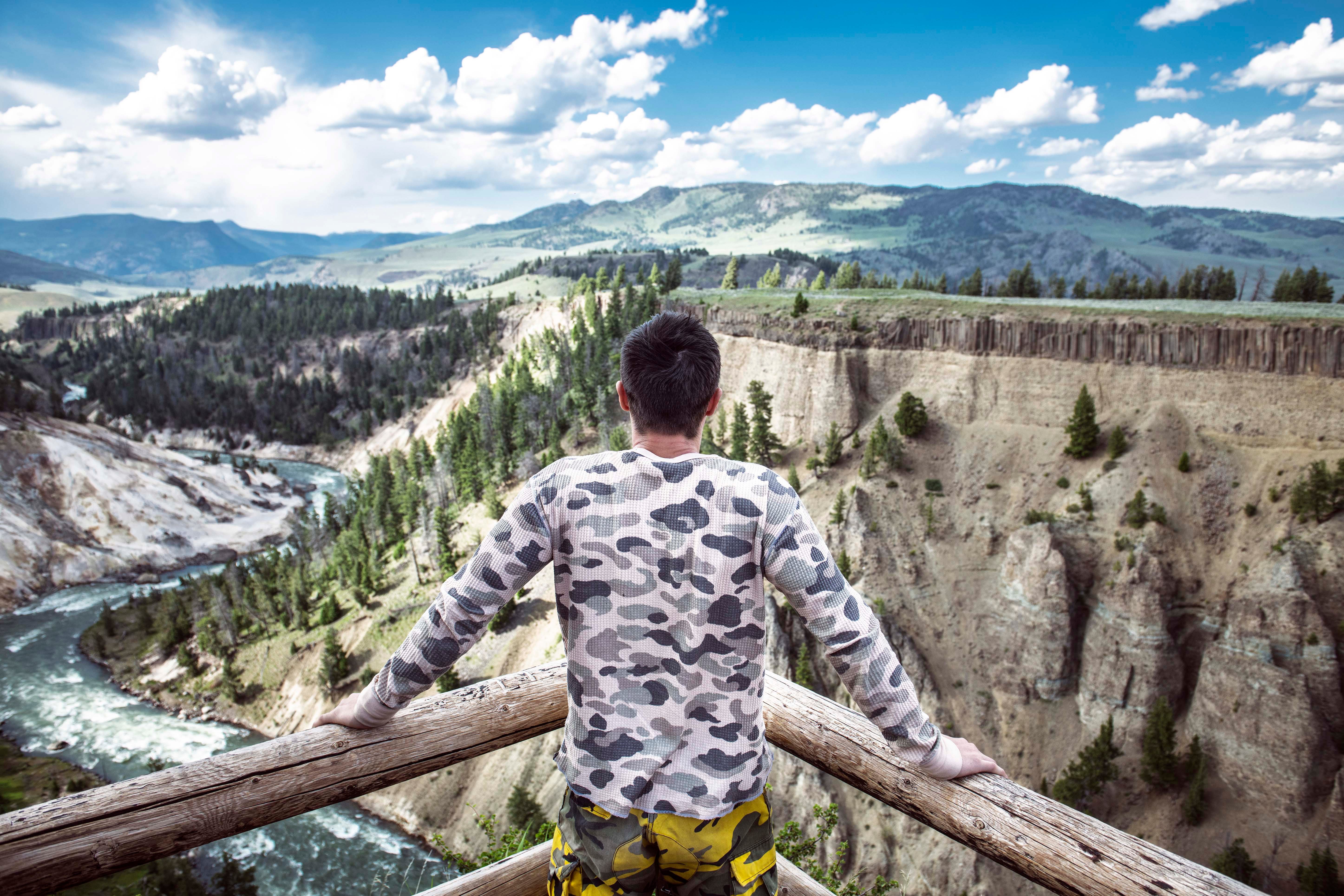 man viewing yellowstone river from overlook