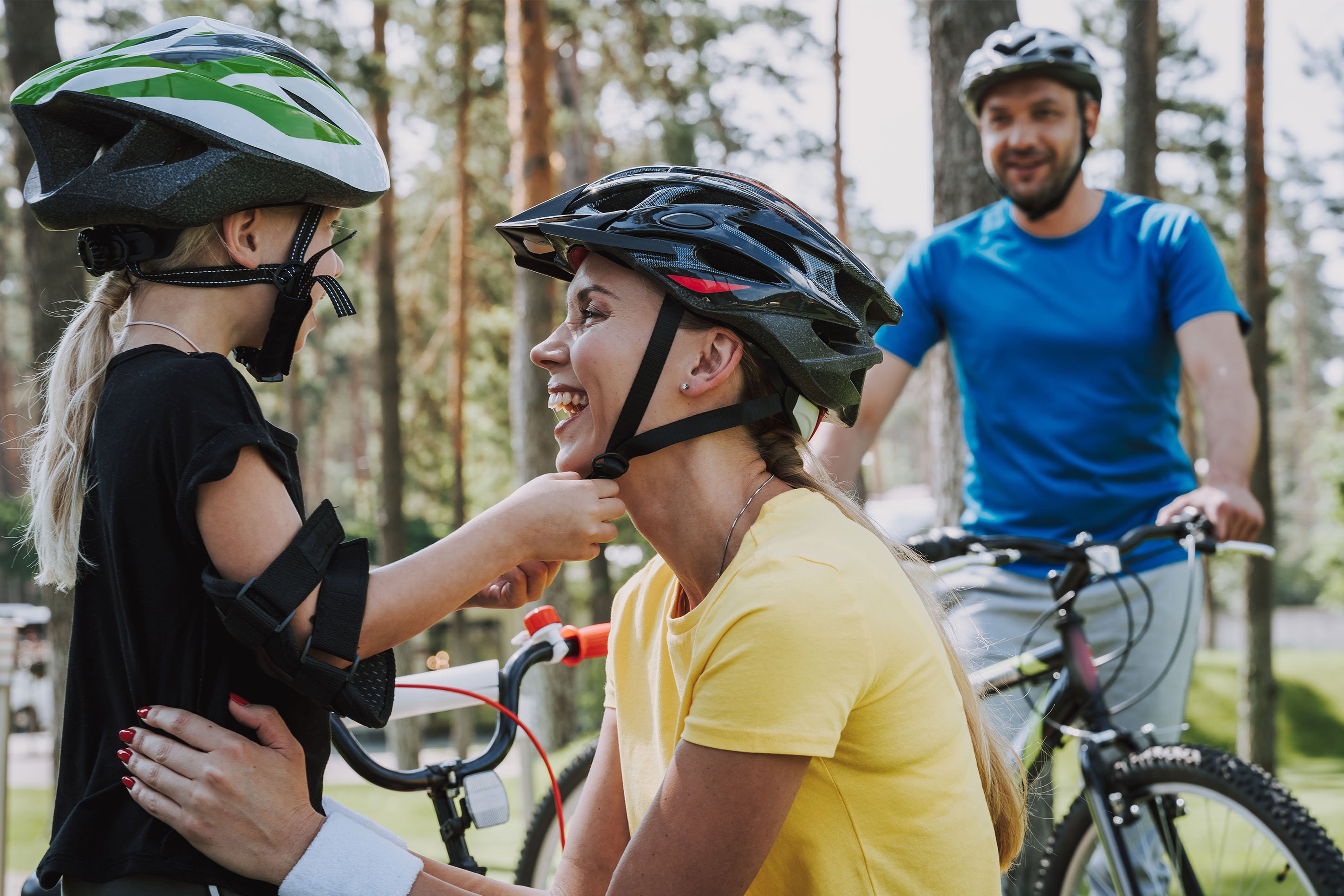 Mother, daughter, and dad biking. 