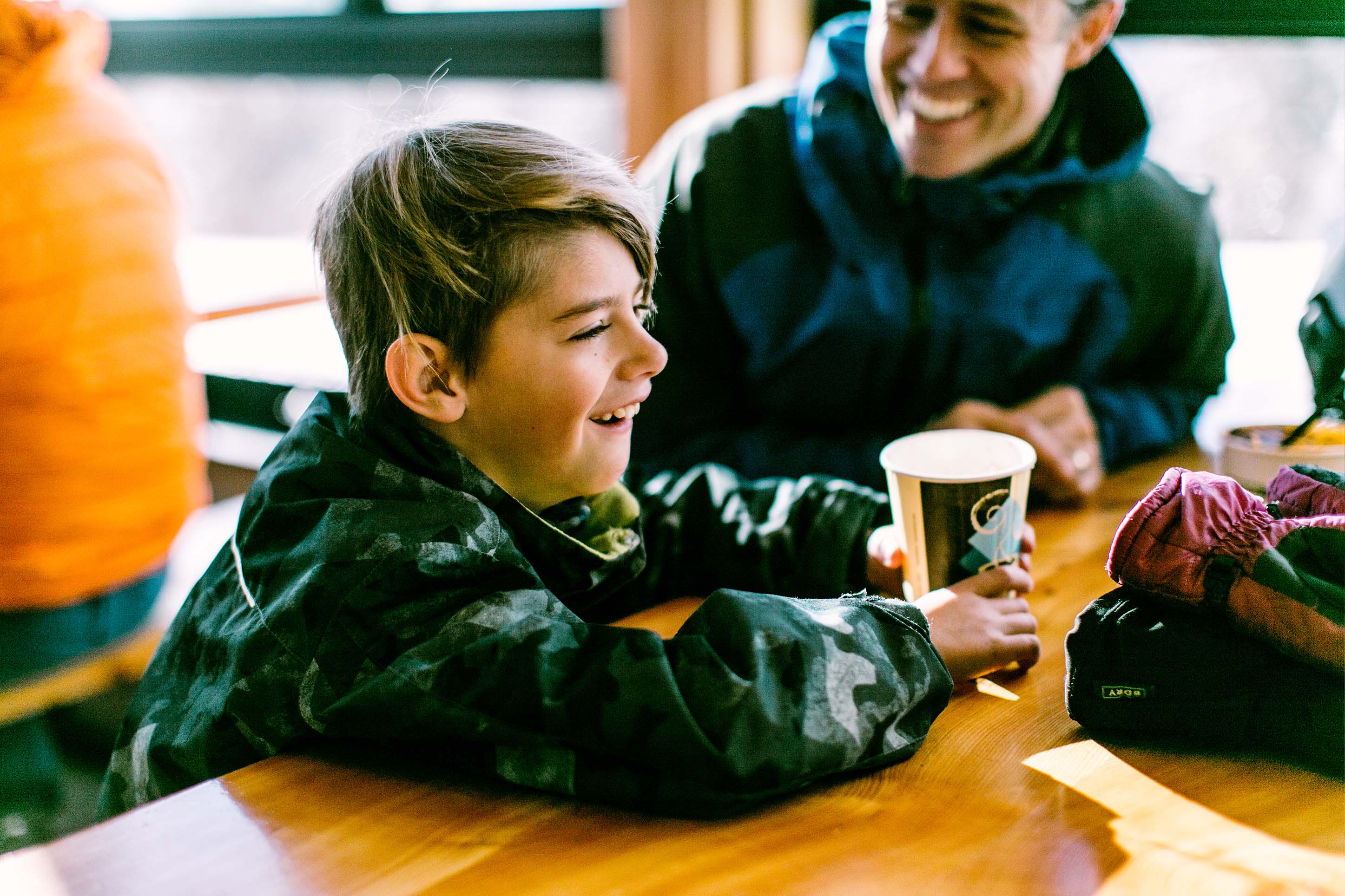 child sips hot chocolate at lodge at Bridger Bowl