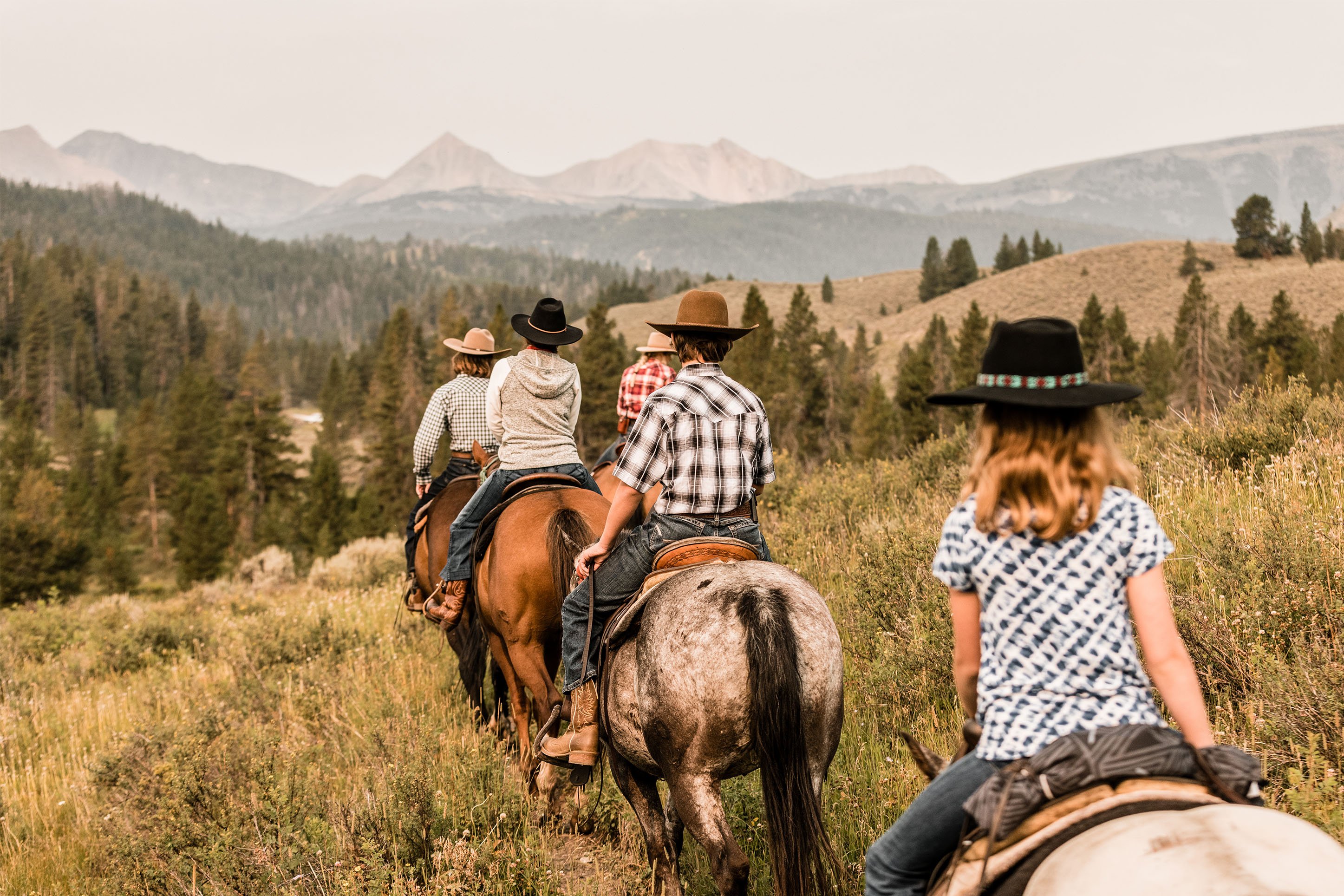 Trail riders on horseback at Nine Quarter Circle Ranch in Montana