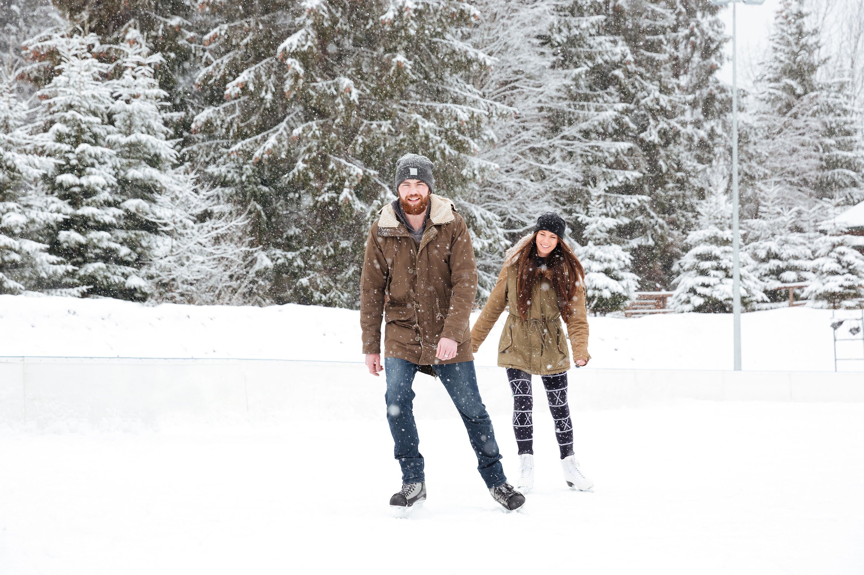 Couple ice skaing on a pond.