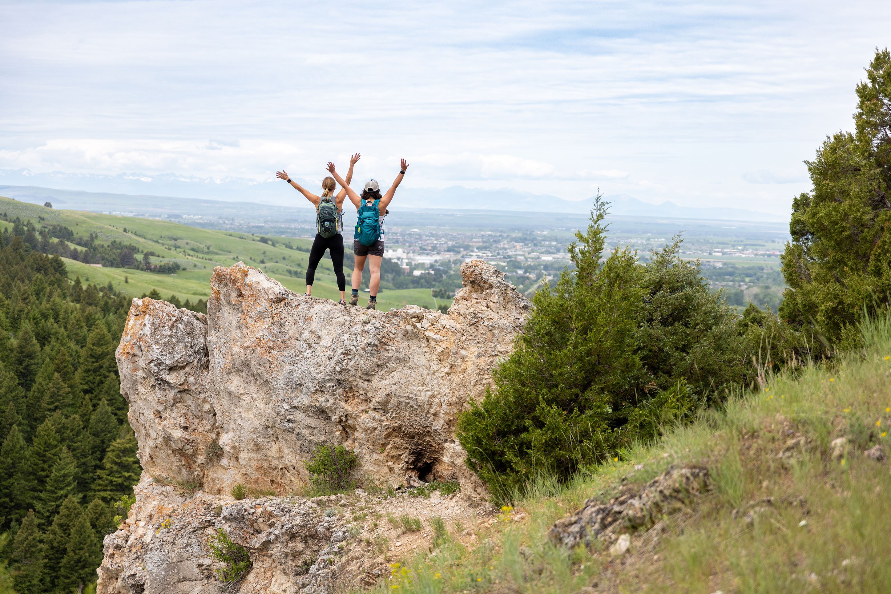 Two hikers looking out over Gallatin Valley