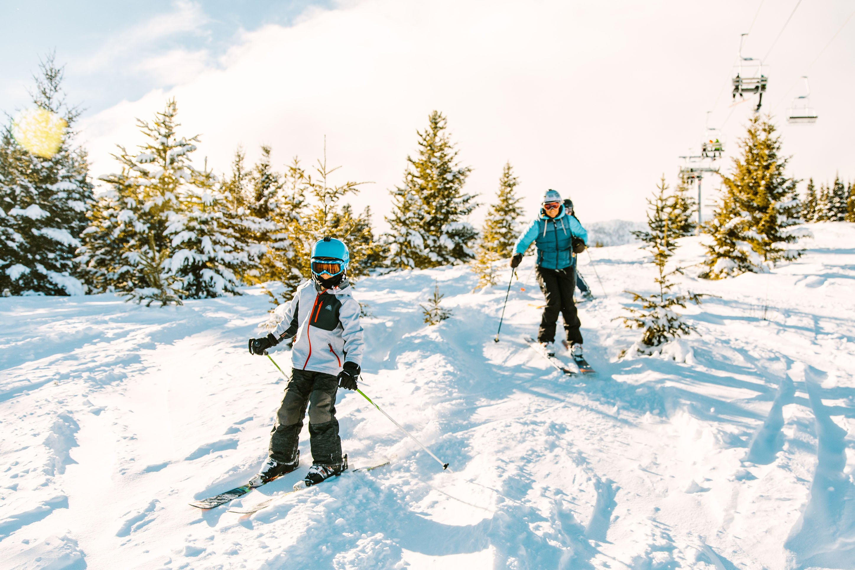 Kid and parent skiing