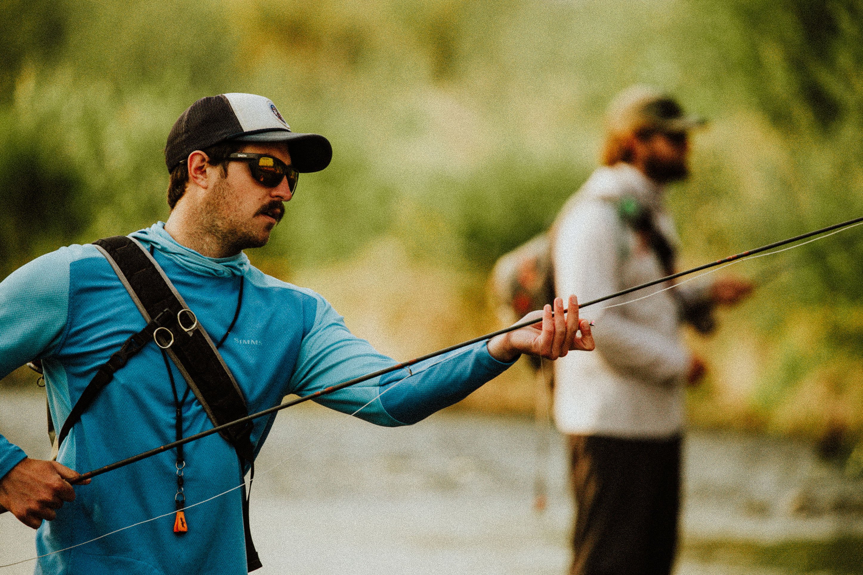 Photo of a man fixing his fishing line