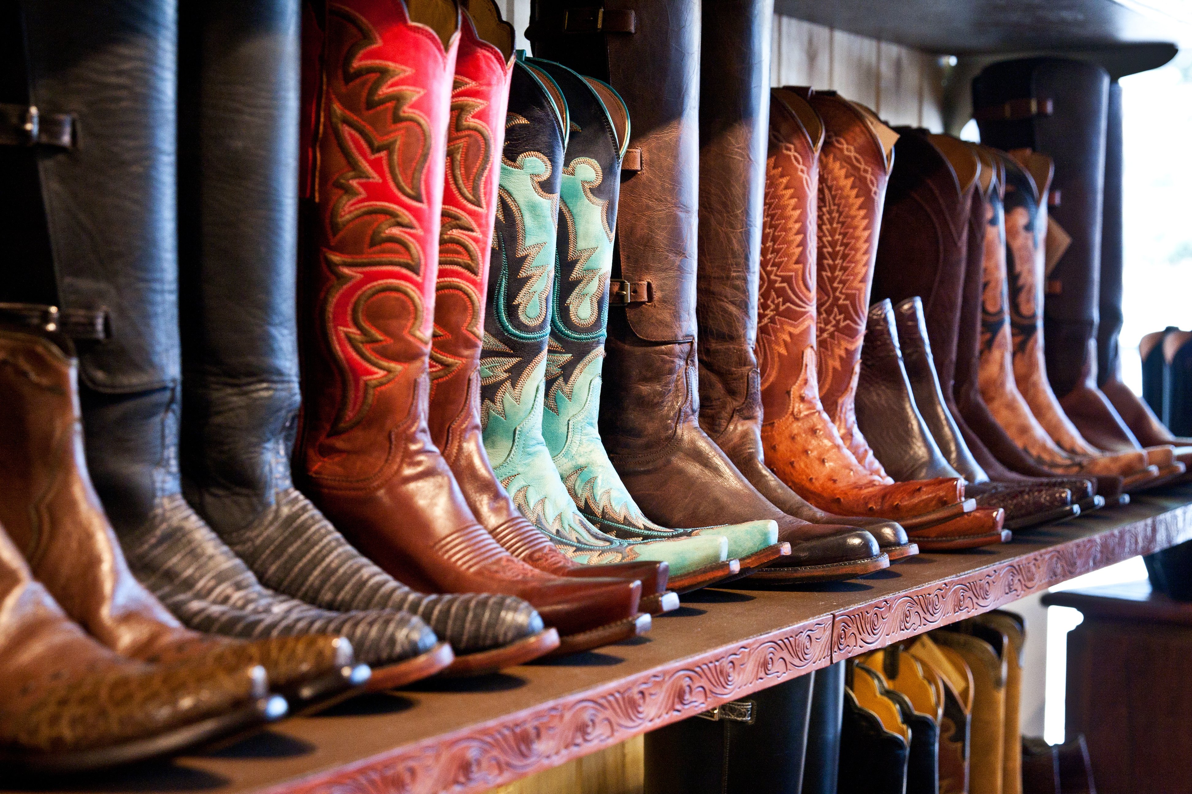 western-style boots lined up on a shelf