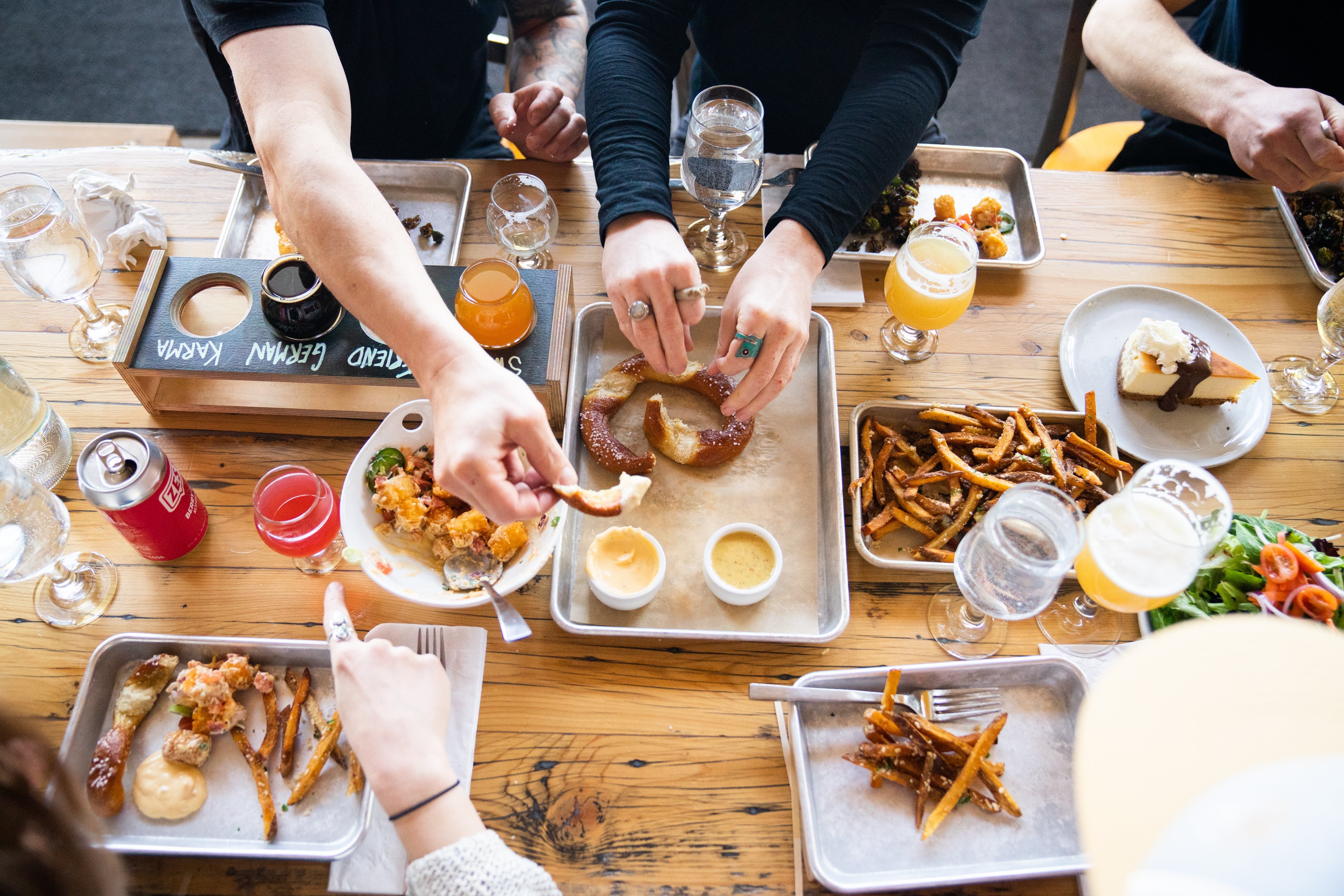 People eating food and drinking beer at Mountains Walking Brewery