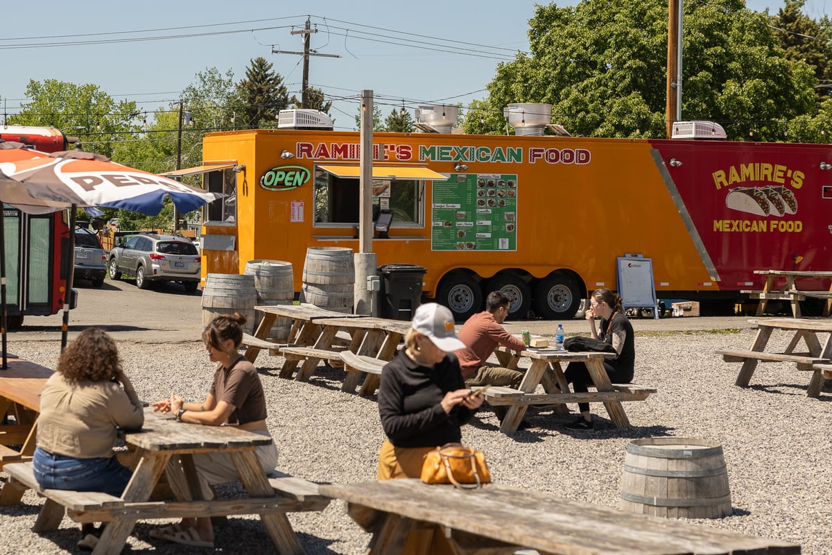 People sitting outside in front of Ramire's Mexican Food Truck on 7th Avenue in Bozeman, Montana