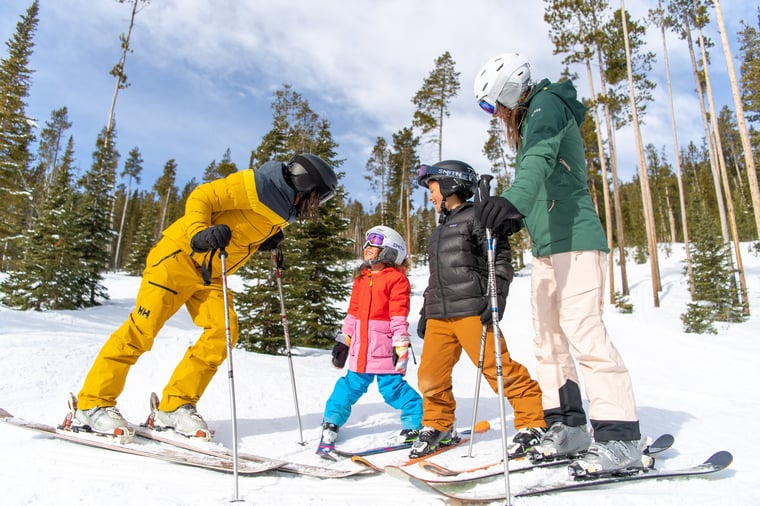 Parents with two small children skiing at Big Sky Resort