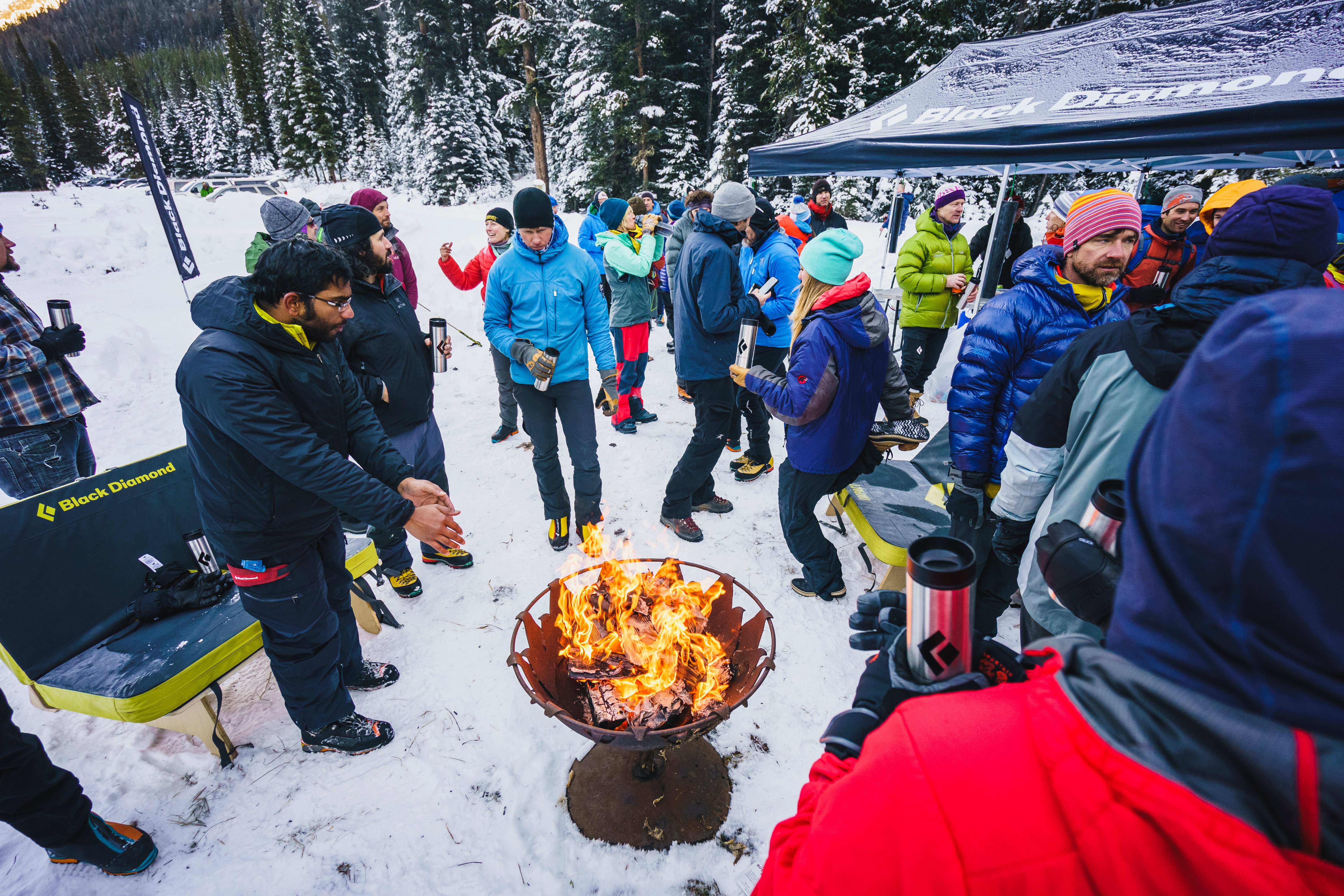 participants gather around a fire at the Bozeman Ice Festival