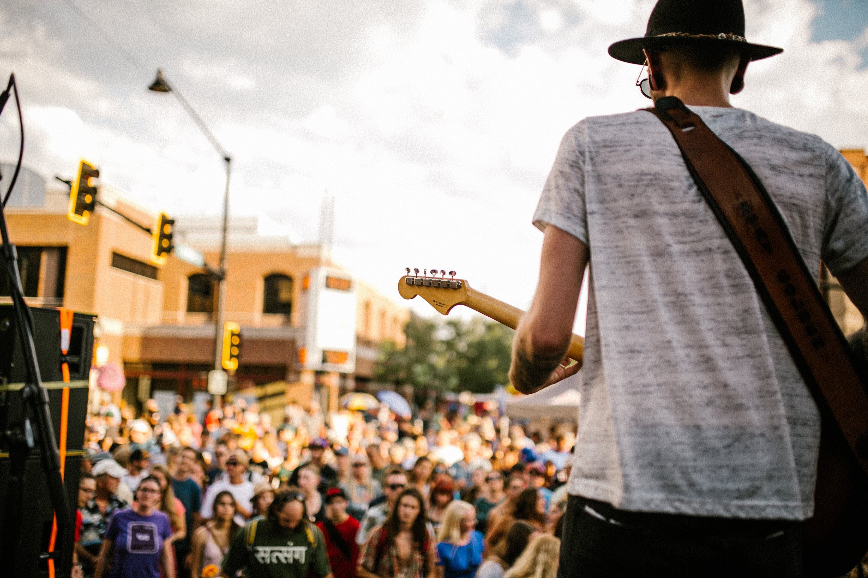 Music on Main band member playing guitar